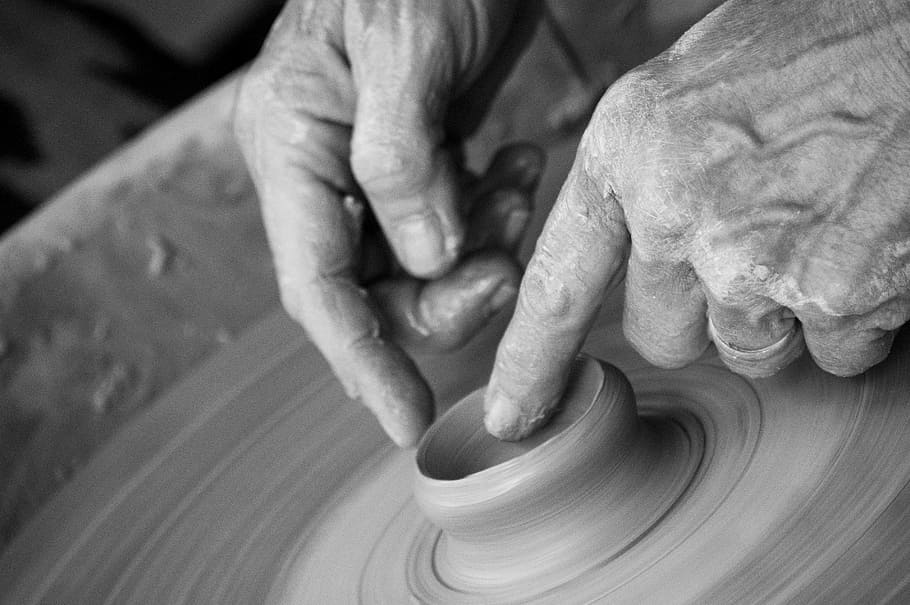 grayscale photograph, person molding vase, hands, clay, pottery, pottery wheel, throwing, wrinkles, wrinkled, elderly