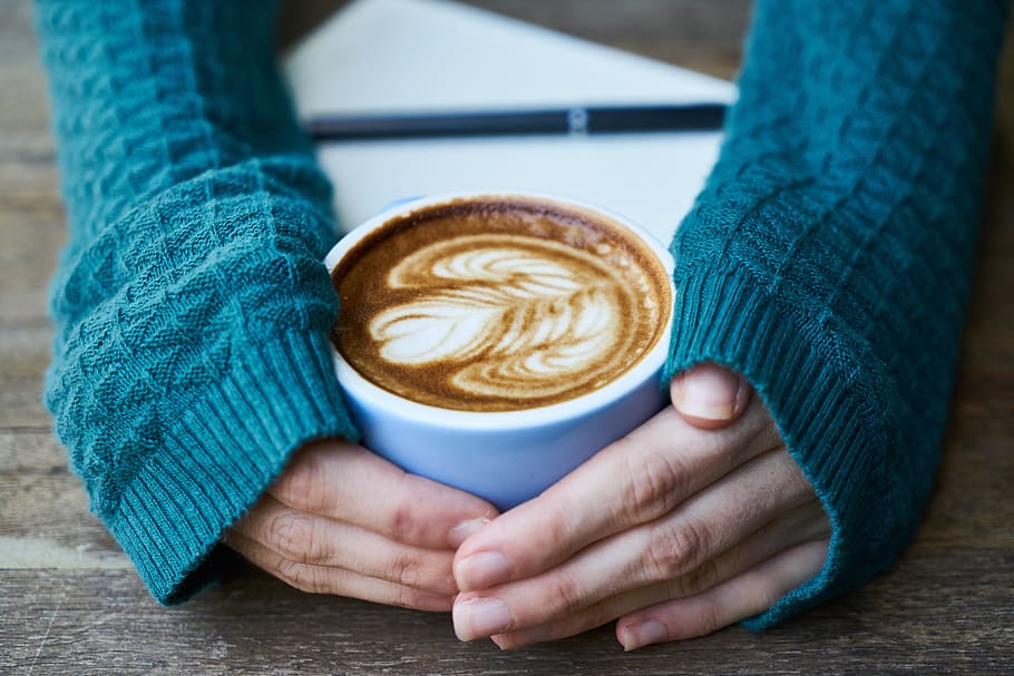 woman, wearing, blue, knitted, long-sleeved, shirt, holding, white, ceramic, teacup