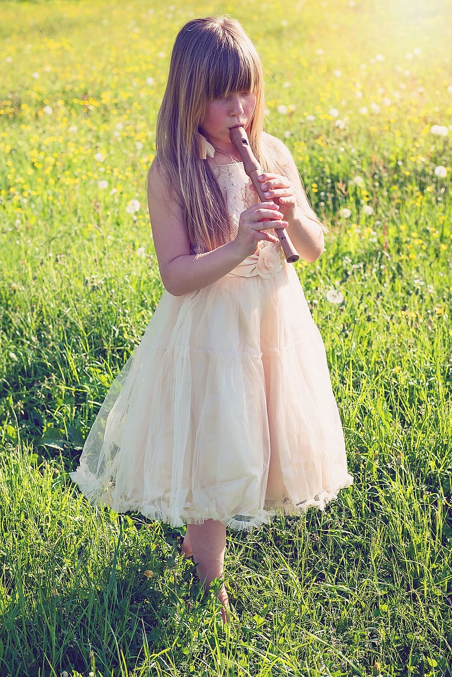 girl, playing, alto recorder, walking, green, grass, daytime, person, human, flute