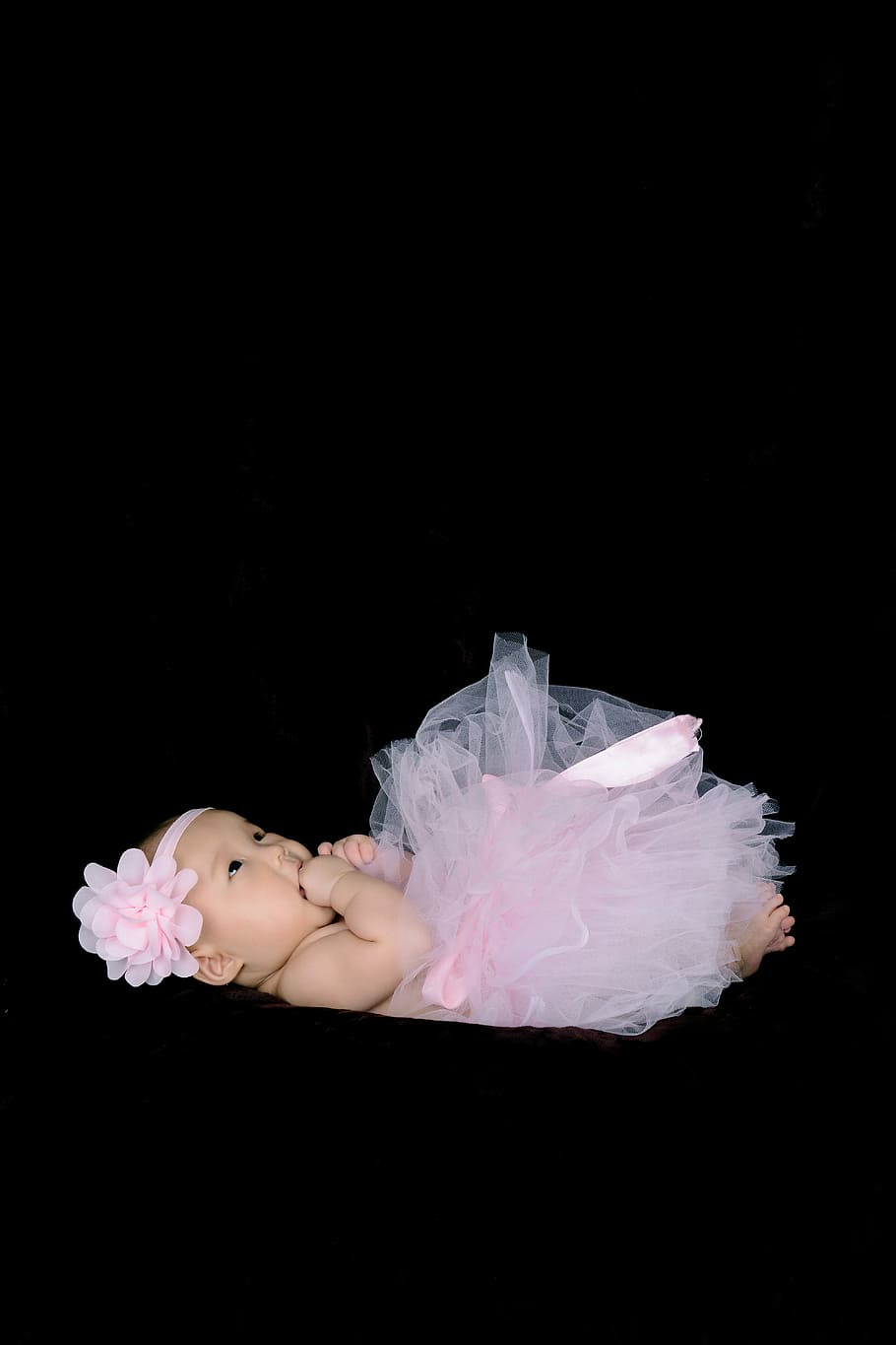 one hundred days baby, girls, be quiet, studio shot, black background, pink color, indoors, one person, copy space, flower