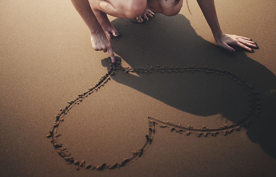 close-up photo, woman, drawing, heart, sand, people, adult, alone, barefoot, beach