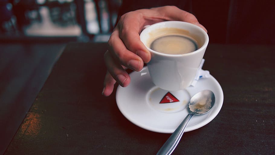 pessoa, segurando, copo, café, mesa, branco, cerâmica, xícara de chá, placa, ao lado