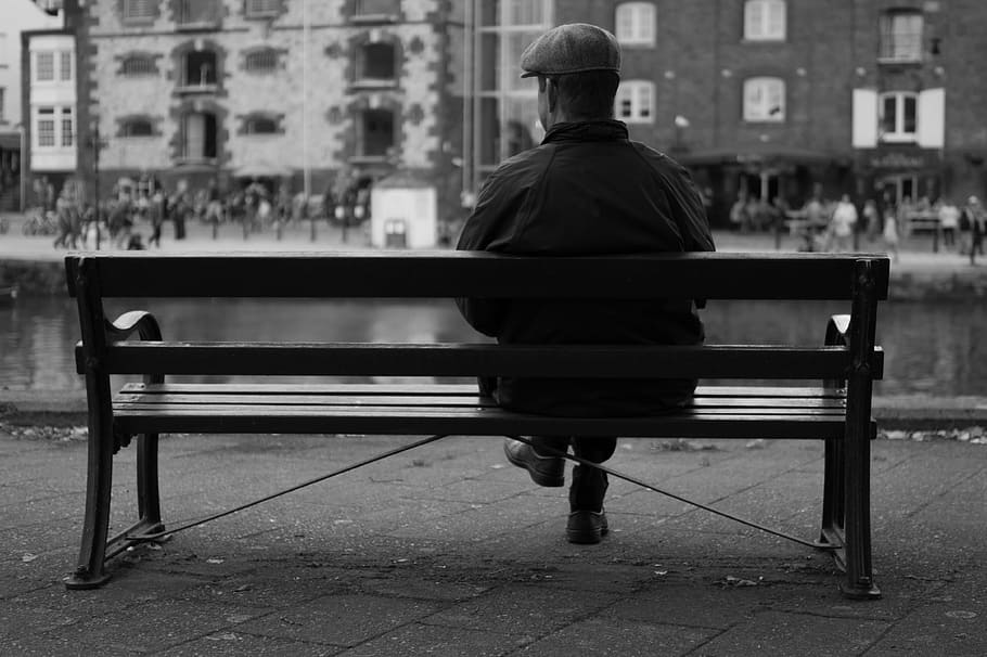 man, sitting, bench front, building, bench, city, waiting, hat, old, view