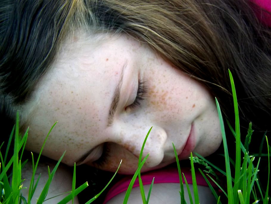 girl, freckles, asleep, grass, portrait, one person, headshot, close-up, young adult, human face