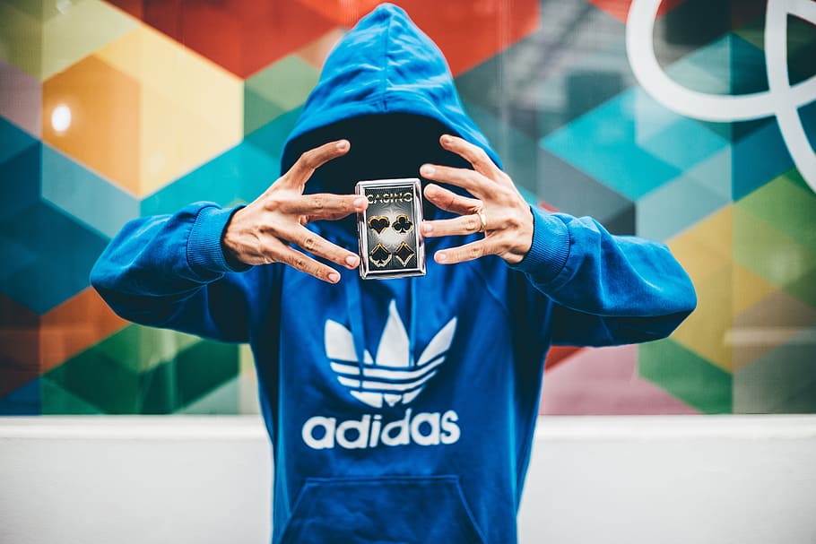 person, wearing, blue, adidas pullover hoodie levitating, playing, card, people, man, cards, anonymous