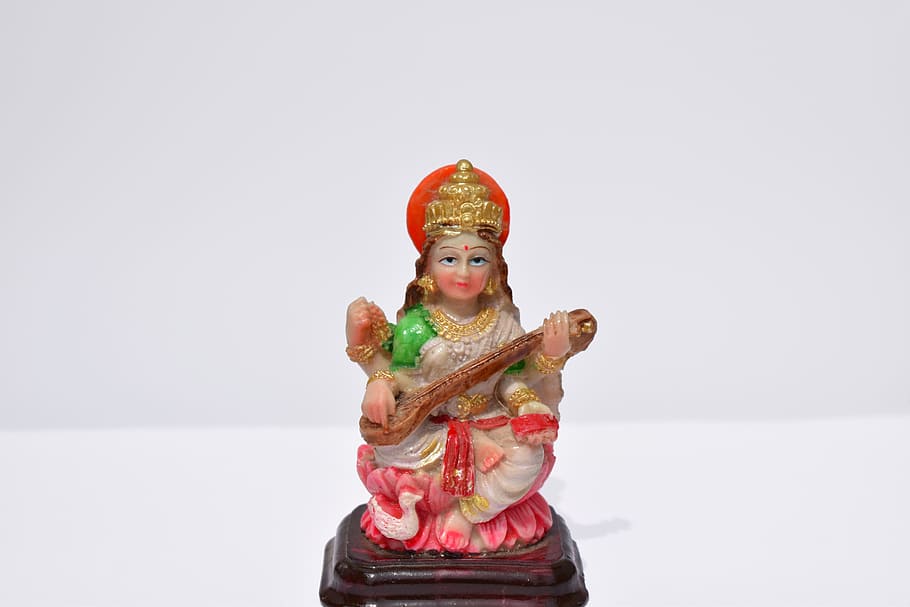 saraswati, india goddess, hindu religion, studio shot, red, white background, childhood, clothing, indoors, one person