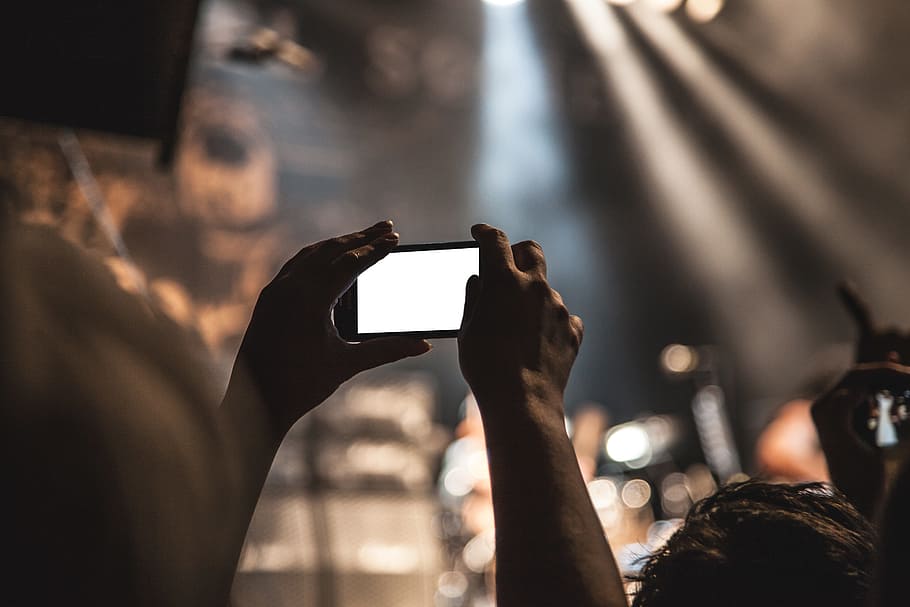 selective, focus photography, person, holds, smartphone, portrait mode, concert, movie, taking pictures, audience