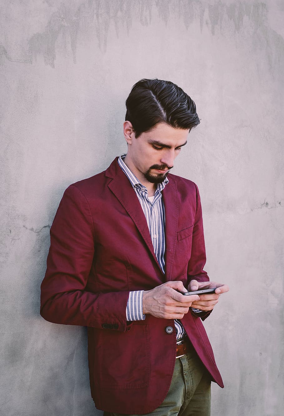 man, leaning, wall, holding, phone, men, maroon, suit, jacket, using