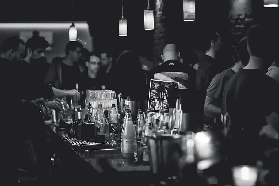 grayscale photo, group, people, bar, human, bottles, beverages, alcohol, lamps, club