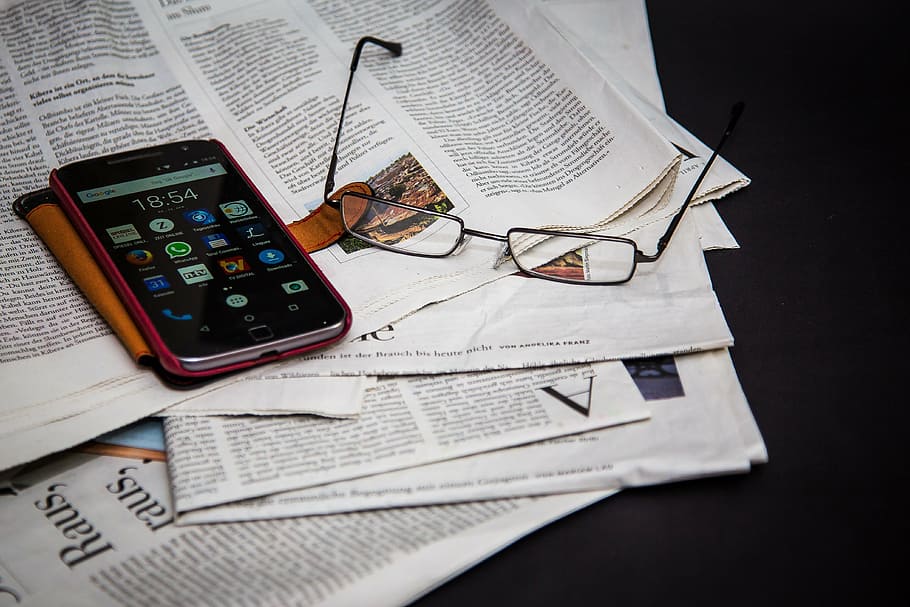 black, motorola android smartphone, brown, flip, case, newspaper, read, information, news, inform