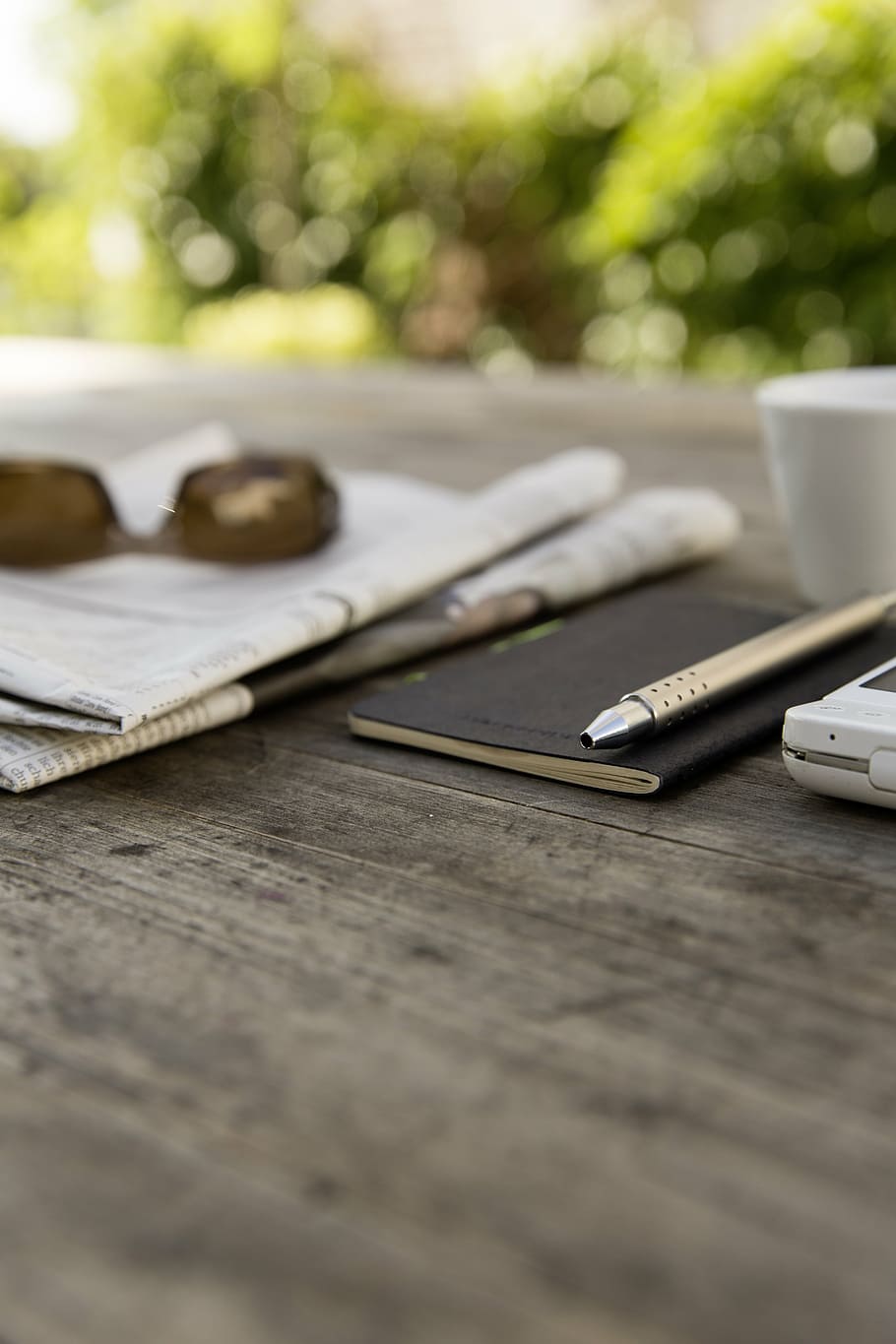 gray pen, smartphone, sunglasses, newspaper, shares, course, chart, notebook, pen, garden