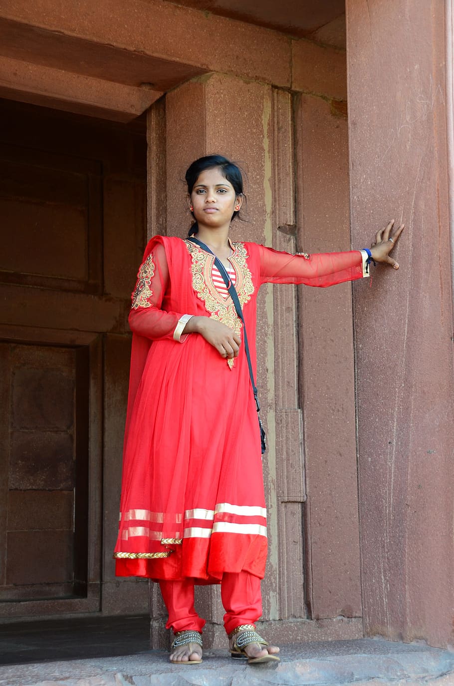 woman, red, abaya, standing, next, brown, concrete, wall, woman in red, india
