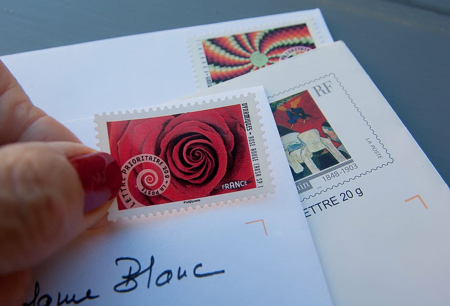 person, holding, red, white, postage stamp, stamps, letters, mail, correspondence, post
