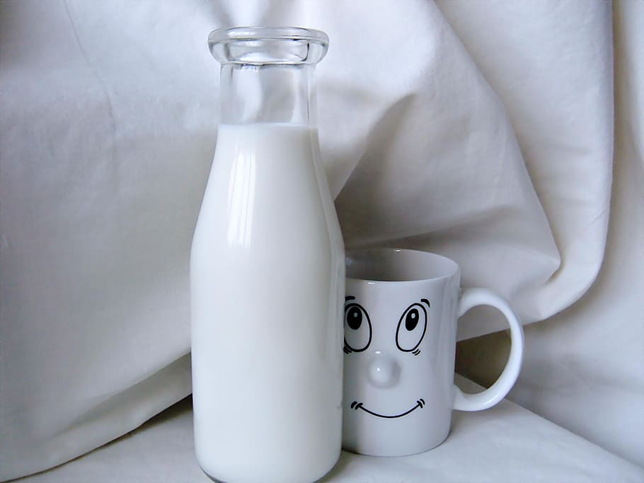 person, taking, milk glass bottle, white, ceramic, mug, clear, glass, milk, container