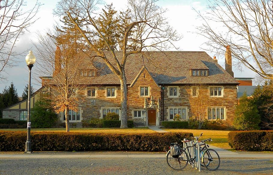 bicycle, white, metal bike rack, overlooking, brown, bricked 2- story building, 2-story, daytime, princeton, new jersey