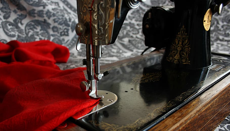 black, treadle sewing machine, sewing machine, antique, vintage, red, indoors, hanging, day, close-up