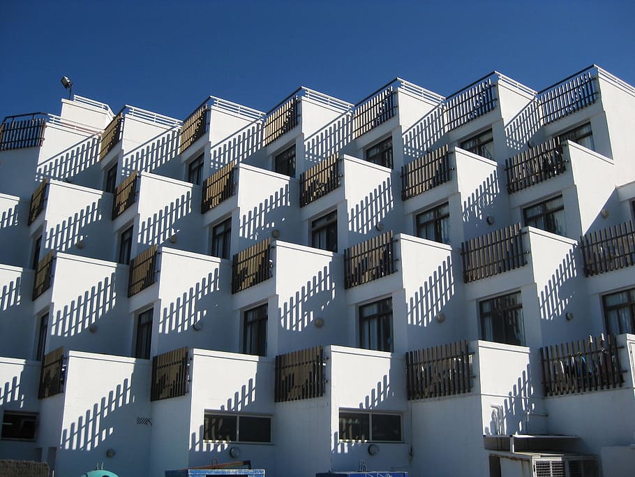 white, concrete, residential, buildings, daytime, building, balconies, balcony, sunshine, shadows
