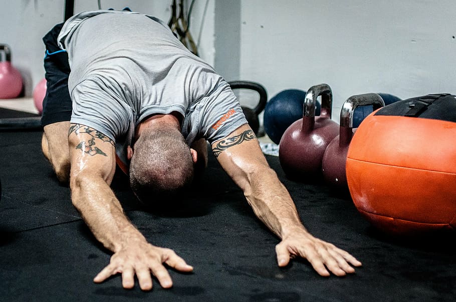 body builder, laying, hands, floor, kettle dumbbells, kettlebell, stretching, fitness, crossfit, fit