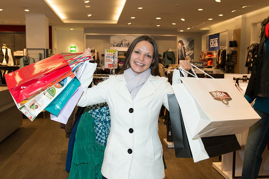 woman, white, coat, holding, paper bags, shopping, happy, bags, dresses, andi garba