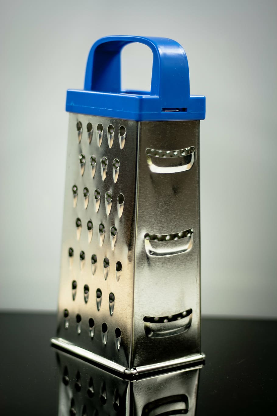 grater, countertop, kitchen, food, cooking, indoors, technology, blue, close-up, single object