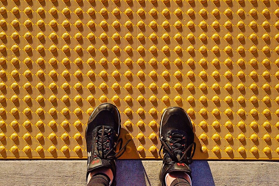 safety tread, sidewalk, tread plate, yellow, tactile paving, curb, grip, shoe, low section, human body part