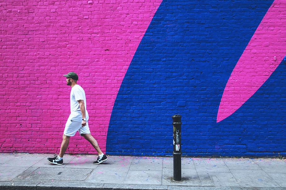 man, walks, past, coloured, brick wall, east, london, East London, people, graffiti