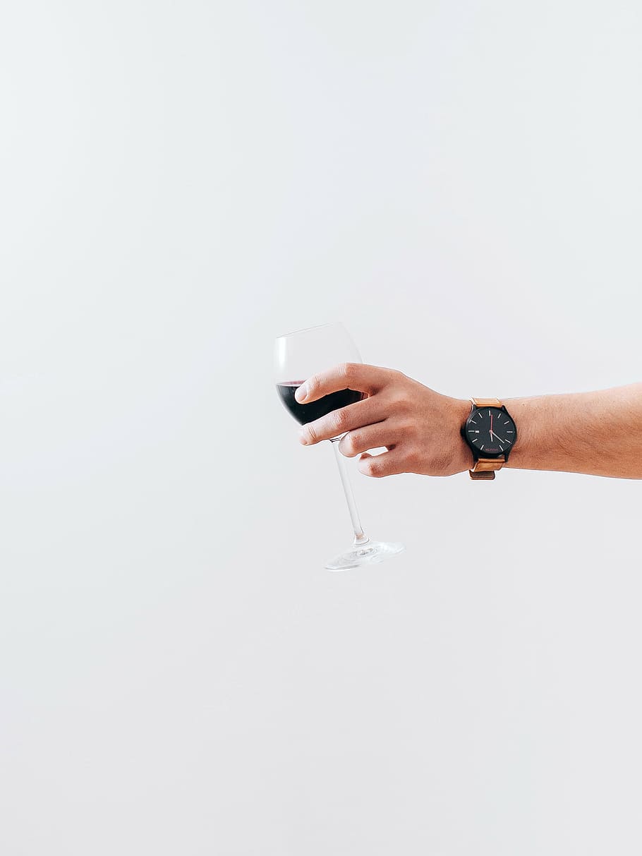 person, holding, clear, wine glass, black, liquid, wearing, watch, wine, glass