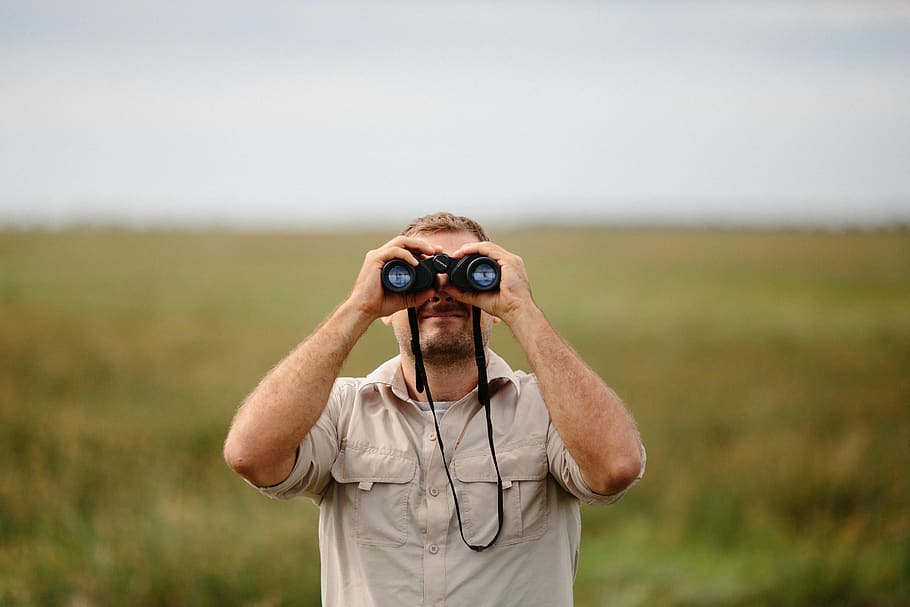 people, man, binoculars, green, nature, landscape, one person, front view, waist up, focus on foreground