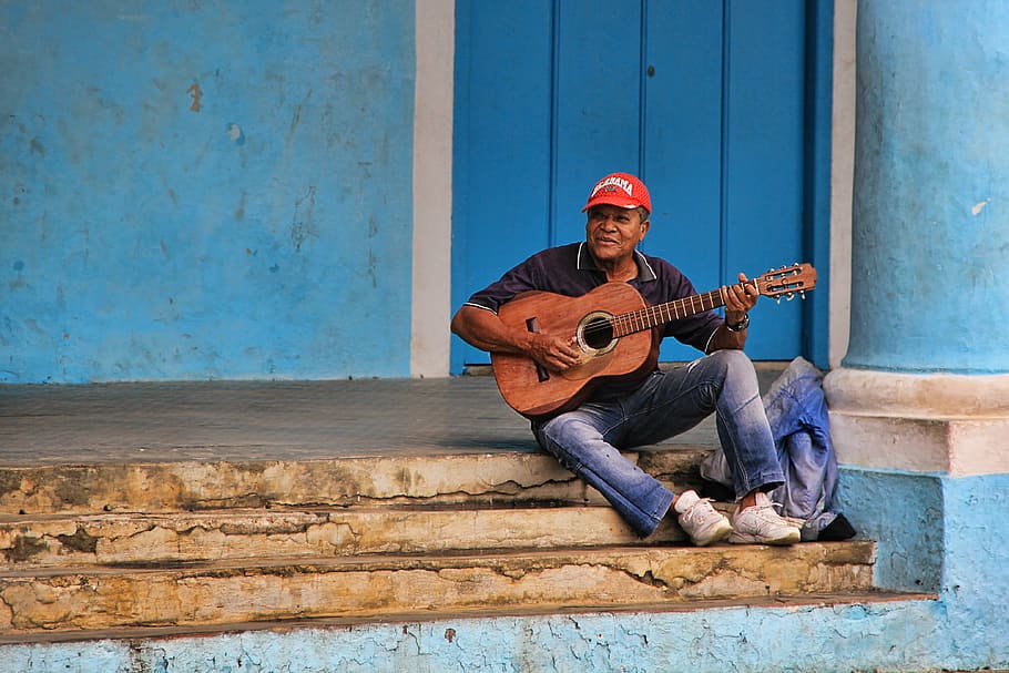 man, wearing, black, polo shirt, sitting, stairs, playing, acoustic, guitar, musician