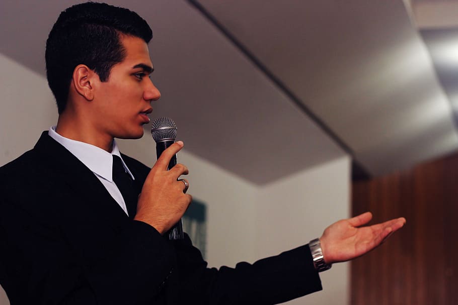 man, wearing, black, suit jacket, holding, microphone, presenter, master of ceremony, lecture, events