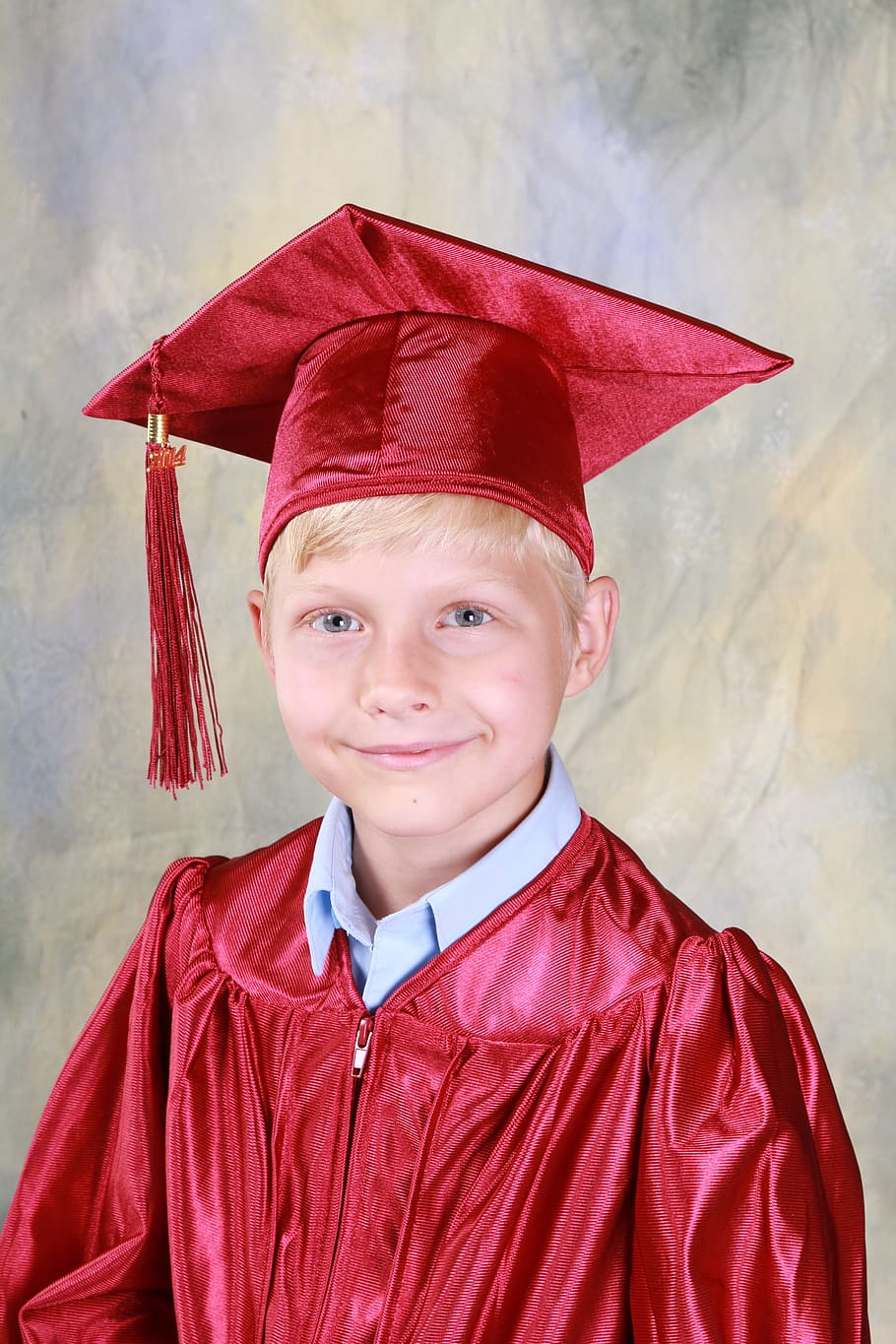 smiling, boy, wearing, red, silk, academic, gown, mortar board, graduation, kindergarten