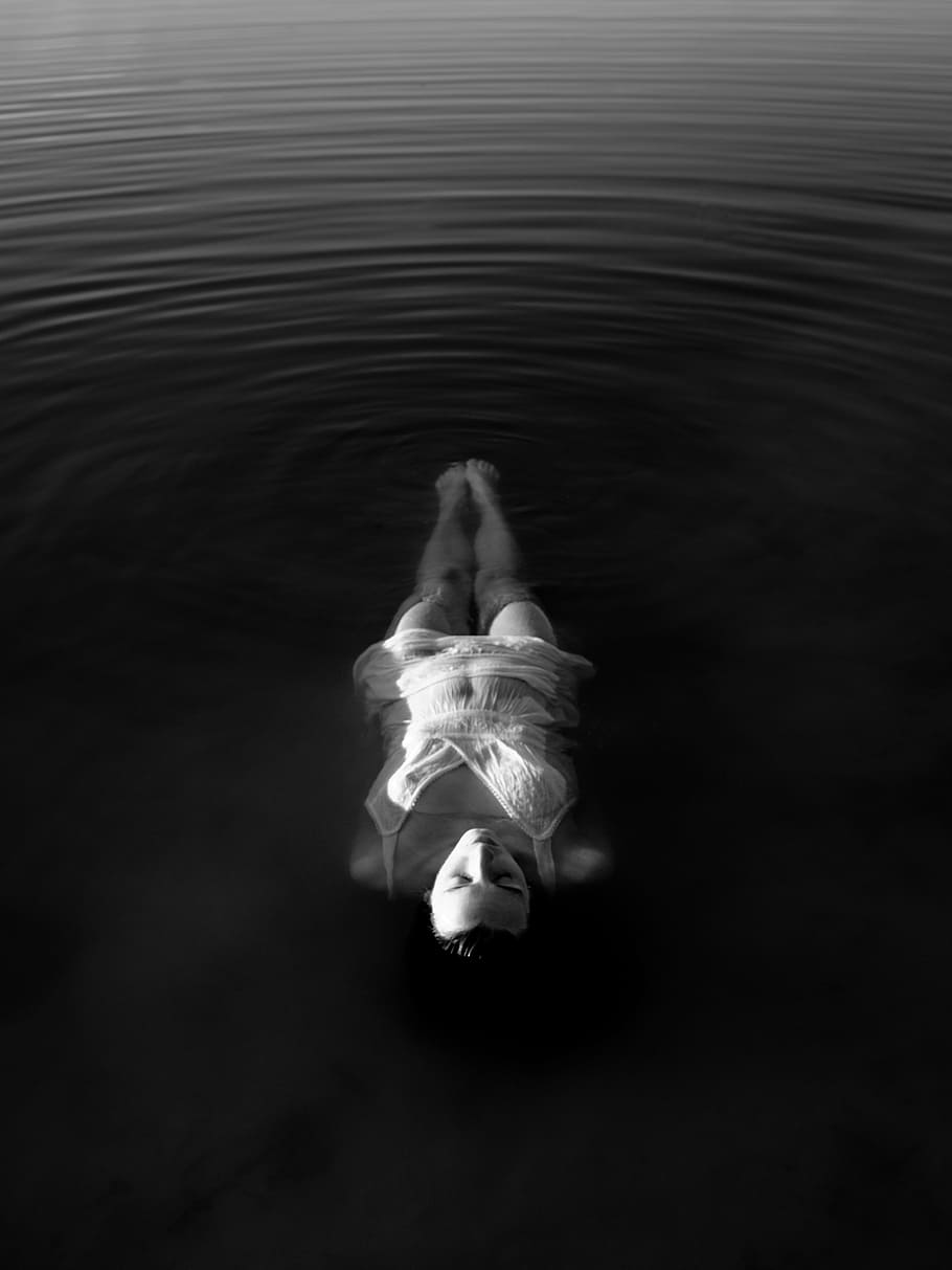 grayscale photo, woman, floating, body, water, wearing, white, dress, people, swimming