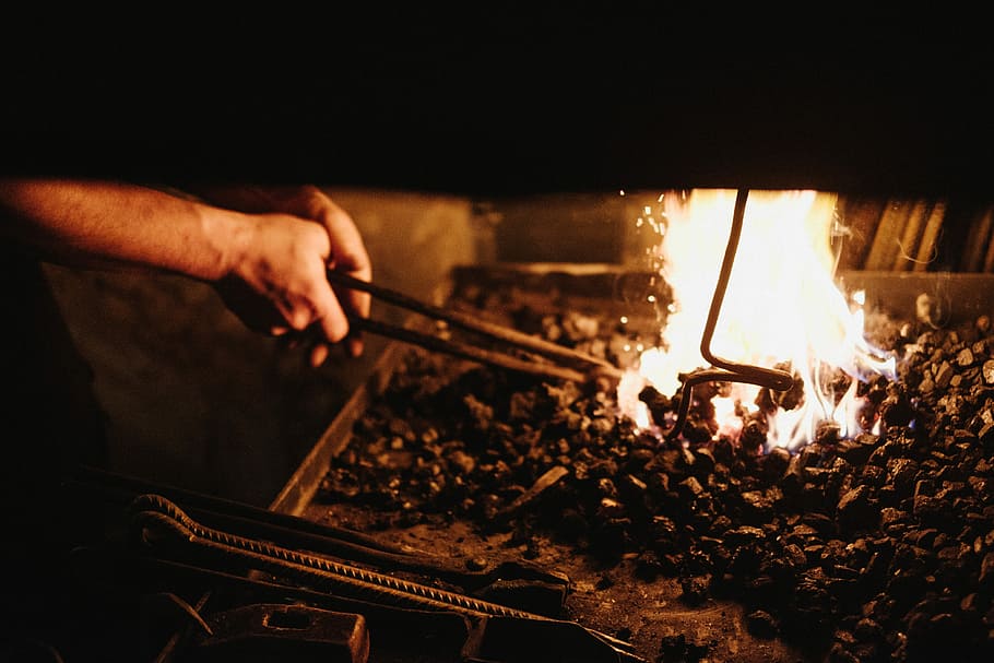 person, holding, black, metal tong, fire, black metal, tong, fire - Natural Phenomenon, heat - Temperature, flame