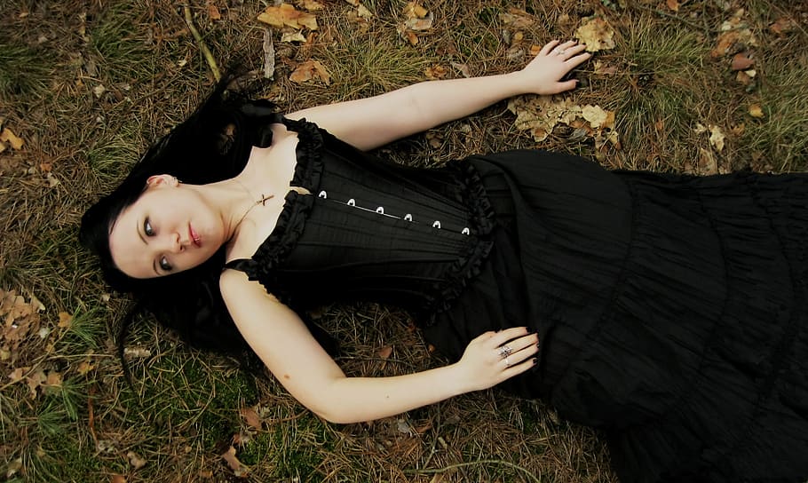 woman, black, sleeveless dress, lying, green, grass field, woman in black, sleeveless, dress, green grass
