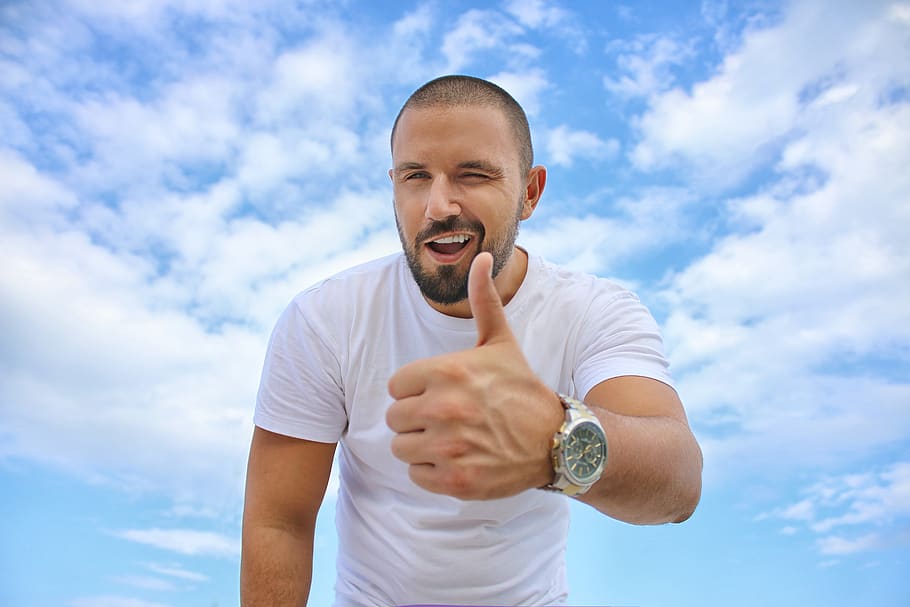 man, thumbs up, wink, smile, happy, blue sky, clouds, white, t shirt, watch