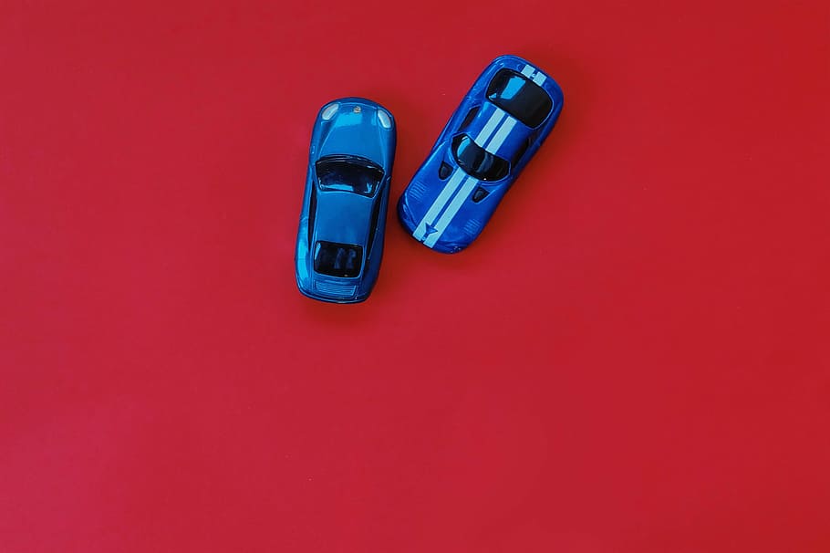 two, blue, die, cast toy cars, red, wooden, table, top, die cast toy, toy cars
