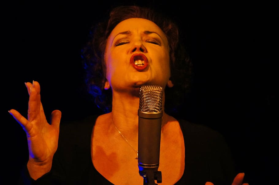 woman, wearing, black, scoop-neck, top, singing, front, condenser microphone, sing, singer