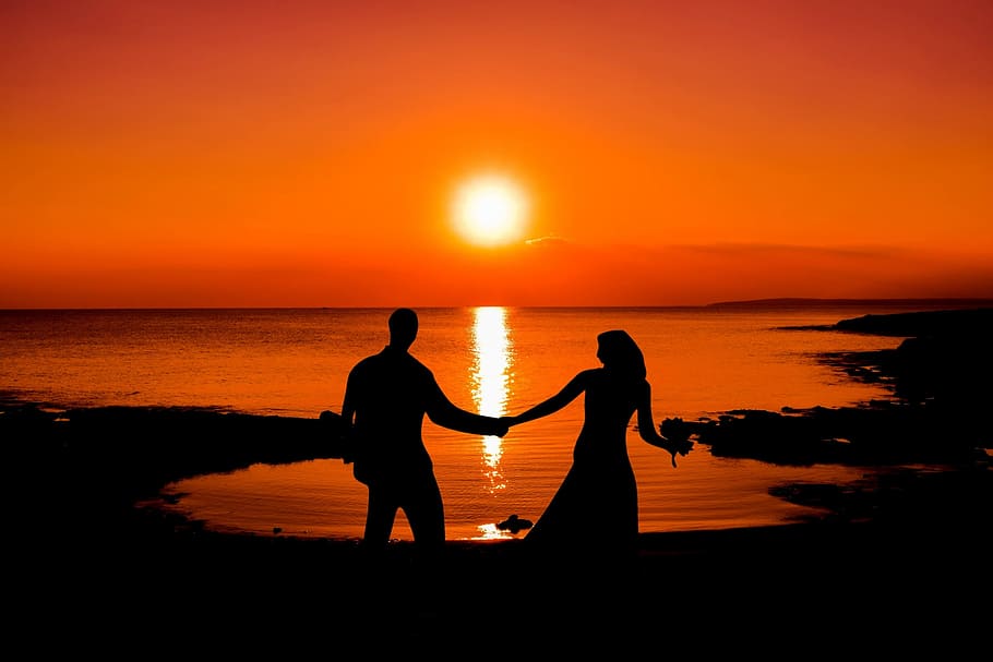 silhouette, man, woman, holding, hand, stands, ocean, sunset, sun, evening sky