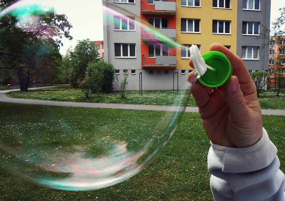 bubble, bubble blower, hand, green, grass, prefabs, trees, macro, lawn, building exterior