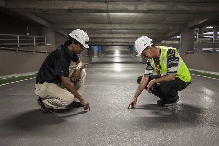 two, men, pointing, grey, floor, inside, underground, onsite, man, construction