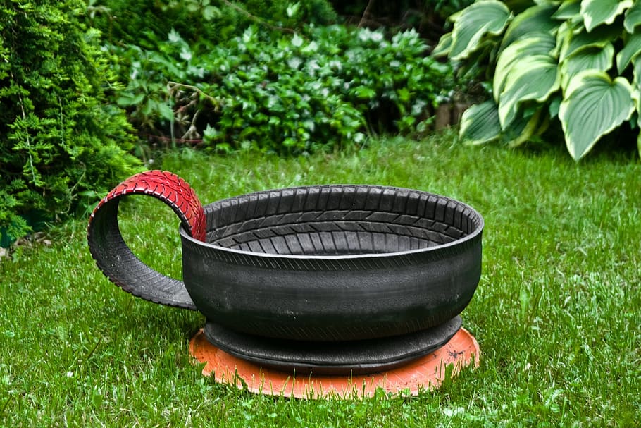 black, tire teacup garden decor, lawn, daytime, tire recycling, grass, green, gold, painted, flower pot
