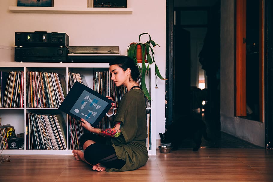 woman, sitting, reading, records, vinyl, music, home, casual, tattoo, female