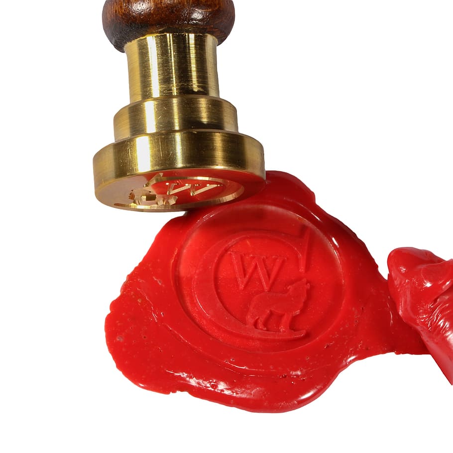 brass-colored wax stamp, seal, sealing wax, stamp, red, notarize, contract, studio shot, white background, indoors