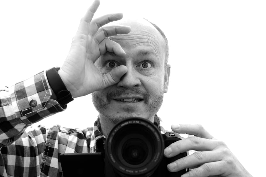 grayscale photo, man, holding, black, dslr camera, photographer, hand, characters, in focus, mirror