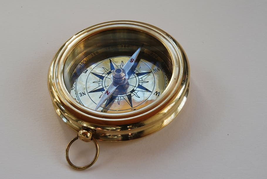 round gold-colored compass, compass, direction, north, to find, navigation, south, discovery, guidance, exploration