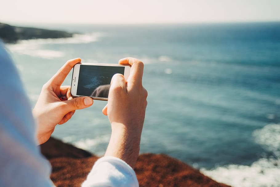 person, holding, iphone, black, case, phone, phone camera, camera, scenery, ocean