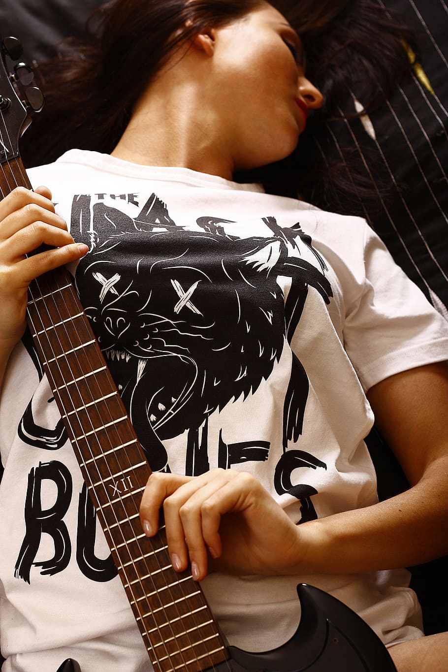 woman, white, black, crew-neck shirt, holding, brown, electric, guitar, girl, musician