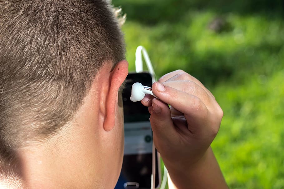 headphones, ear plug, head, ear, hand, listen, listen to, listen to music, message listen, stuck into the ear