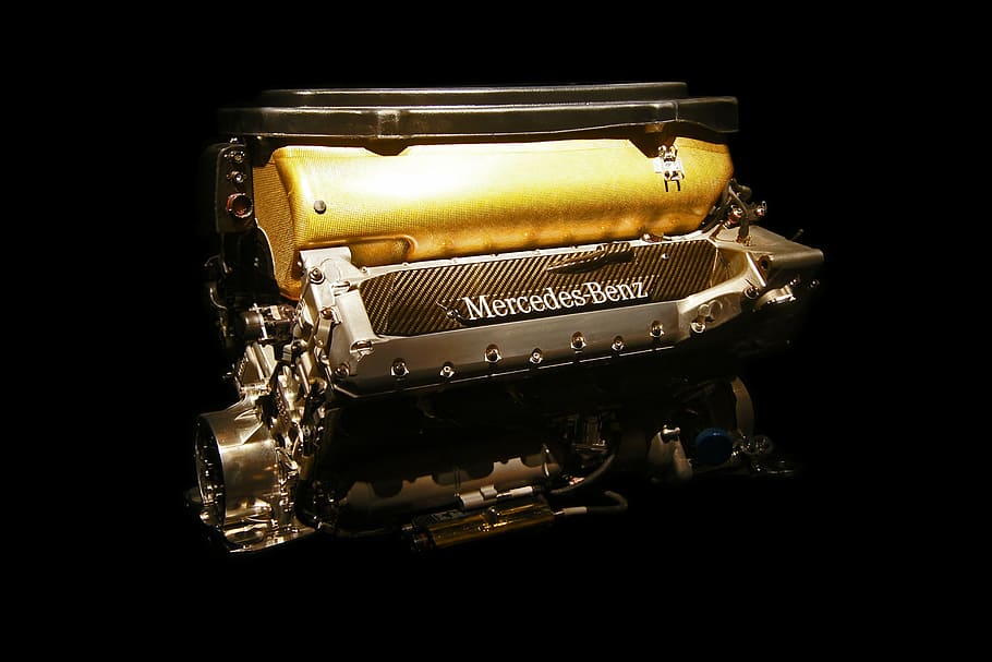mercedes-benz vehicle engine, mercedes engine, car engine, horsepower, yellow, black background, studio shot, close-up, indoors, still life