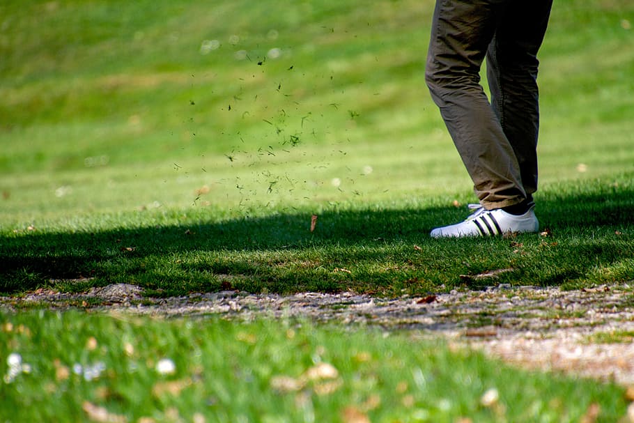 person, wearing, white, shoes, standing, green, grass field, golf, according to the tee, sport